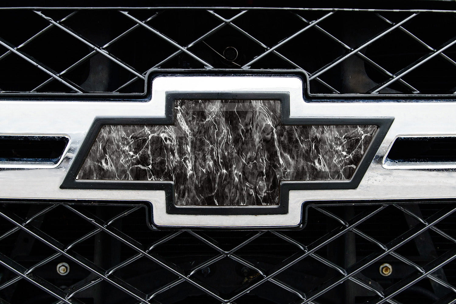 Universal auto emblem peel and stick vinyl with genuine Mossy Oak camo in Agua Blacktip pattern