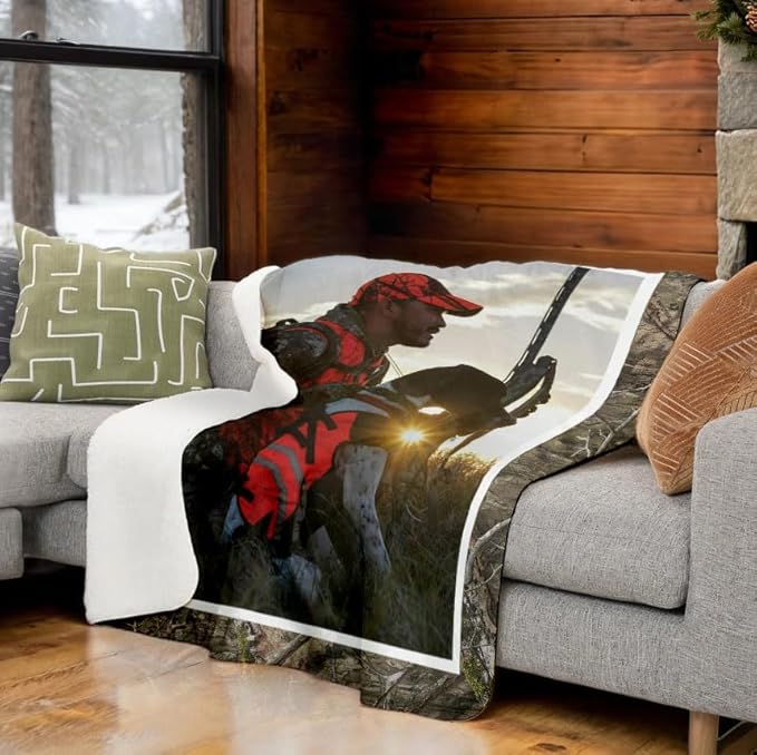 Sherpa fleece backed blanket with custom photo and Mossy Oak Graphics camo border spread on a couch